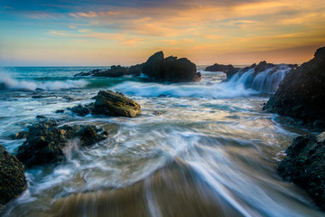 Rocks and waves in the Pacific Ocean at sunset, at Thousand Step