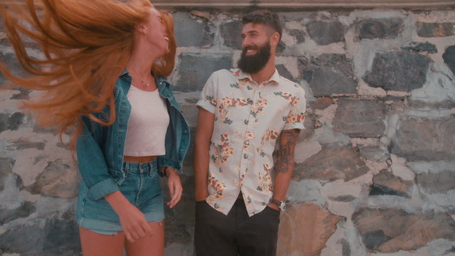 Hipster guy with hipster girl flinging her hair wildly