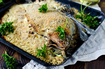 Carp stuffed with rice and mushrooms baked in sour cream