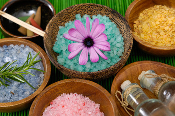 colorful sea salt ,flower, in wooden bowl with orchid on banana leaf 