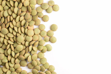Green lentils on a white background.