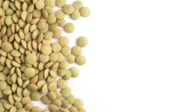 Green lentils on a white background.