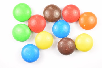 Colorful candies spread on white background.