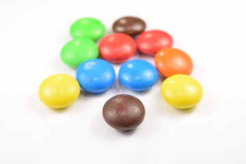 Colorful candies spread on white background.