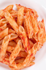 Pasta penne rigate with tomato sauce.