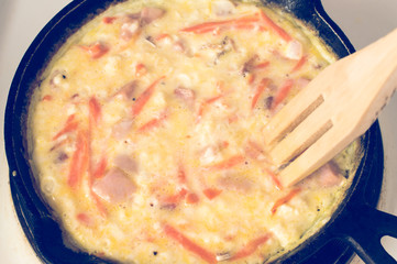 Scrambled eggs with a wooden spoon