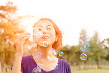 beautiful young woman blowing bubble outdoor happy lifestyle