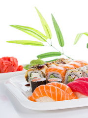Sushi set on white plate over white background