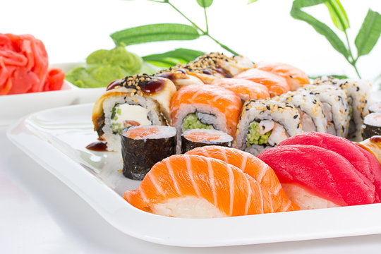 Sushi set on white plate over white background