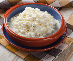 Fresh Cottage cheese on a wooden table