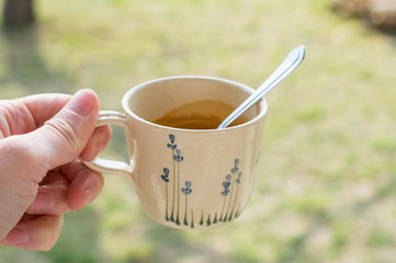 Coffee-cup in my hand in garden