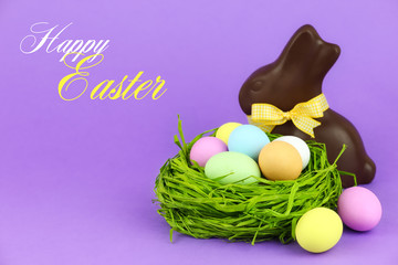Happy Easter greeting card - colourful eggs with chocolate bunny
