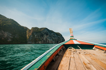 driving a wooden boat in the sea, travel in Thailand