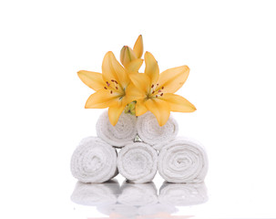 Fototapeta na wymiar Set of yellow lily on stacked roller towels