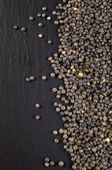 Green lentils on the black deck. Copy space