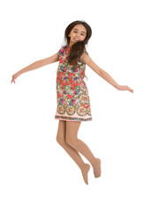 Joyful girl in colorful dress jumps
