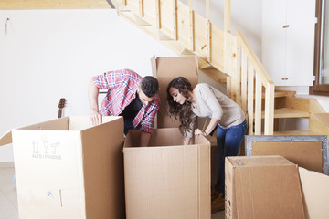 young couple opened the boxes for the new house