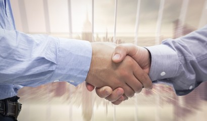 Composite image of two men shaking hands