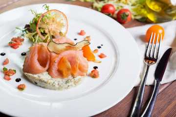 Creative composition delicious fresh smoked sliced salmon with