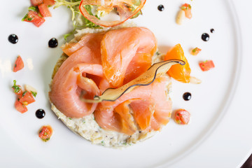 Creative composition delicious fresh smoked sliced salmon with