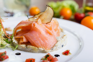 Creative composition delicious fresh smoked sliced salmon with
