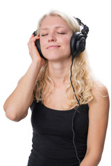 Young blond girl wearing headphones and enjoying music