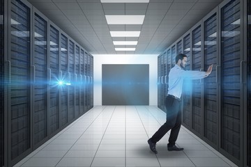 Fototapeta premium Composite image of businessman in suit pushing with effort