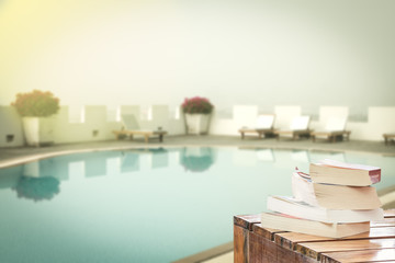 books on table at swimming pool