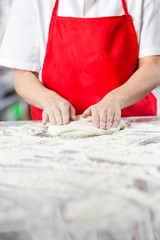 Chef Kneading Dough At Messy Counter