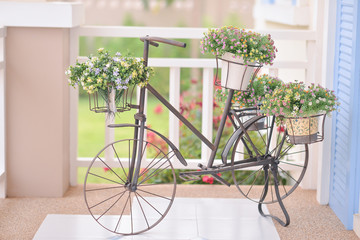 Fototapeta na wymiar Fake flowers in the vase on a bicycle