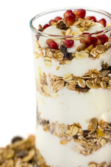 Glass of Muesli with fruits and yogurt isolated on white