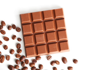 Milk chocolate bar with coffee beans isolated on white