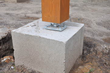 Closeup of wooden pillar on the construction site with screw