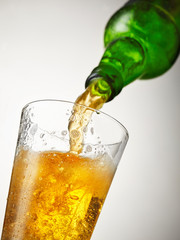 beer is pouring into glass