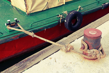 Mooring bollard with naval rope on concrete pier