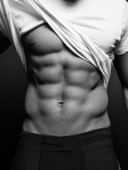 B/w closeup photo of an athletic guy with perfect abs