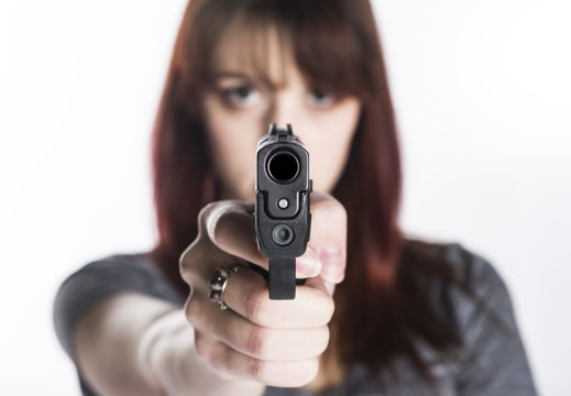 Young Woman Pointing a Gun at the Camera