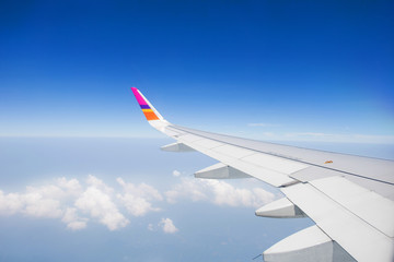 Wing of an airplane flying in the sky