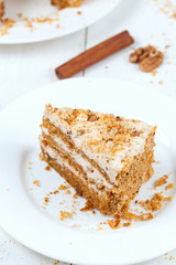 Porttion of handmade sliced carrot cake with cinnamon and walnut