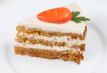 Slice of homemade tasty carrot sponge cake with pastry cream and