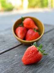 strawberry spill on wood table background