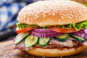 Bacon burger with vegetables and cutlet.