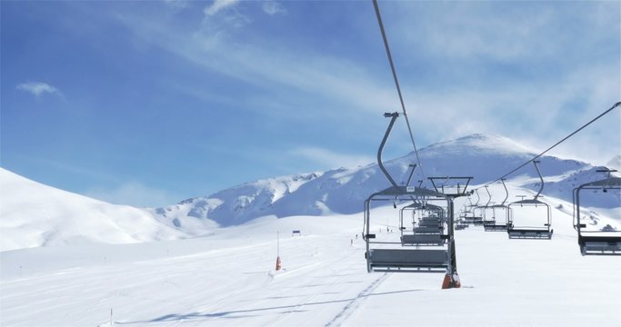 Empty Ski lift with skiers in the background