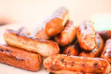 Barbecued beef and pork sausages on white plate