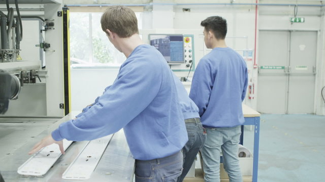 Mixed ethnicity team of machine operators in a factory