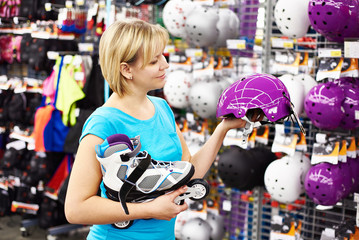 Girl chooses helmet for roller skating