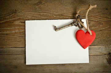 Handmade Heart with key together lying on the paper for message