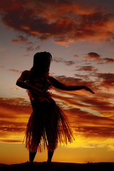 silhouette of Hawaiian woman grass skirt dancing
