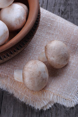 Champignons in a ceramic plate on old wood table