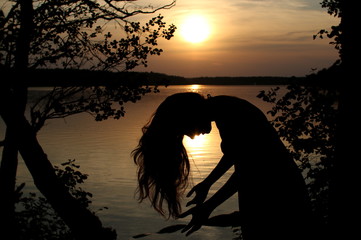 kobieta w jeziorze o zachodzie słońca